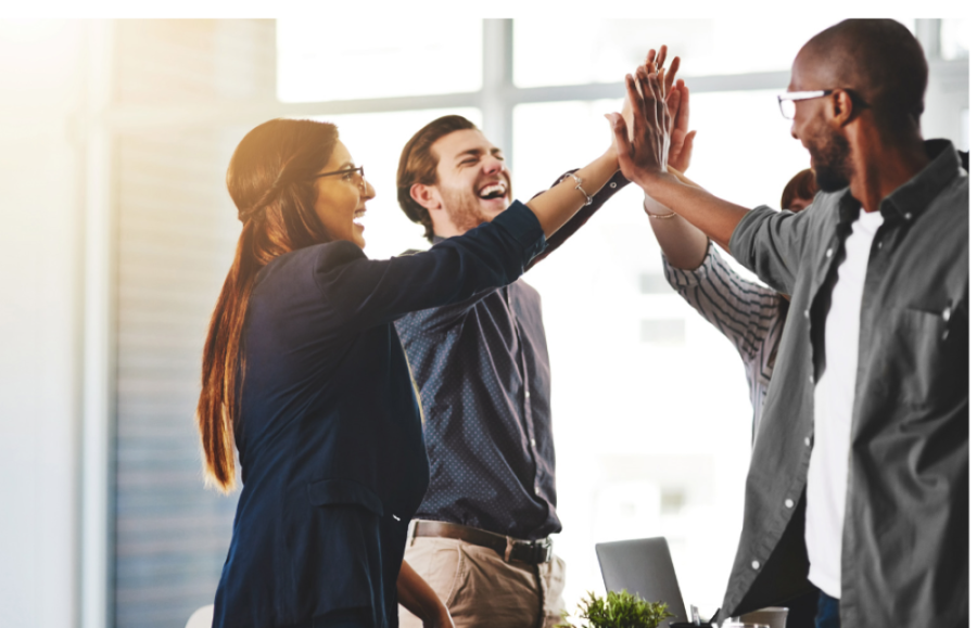 A group of people giving each other a high five.