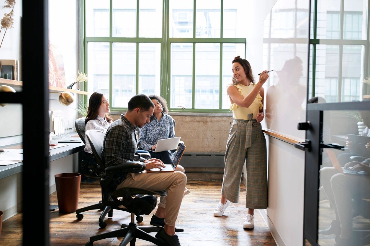 A group of people in an office setting.