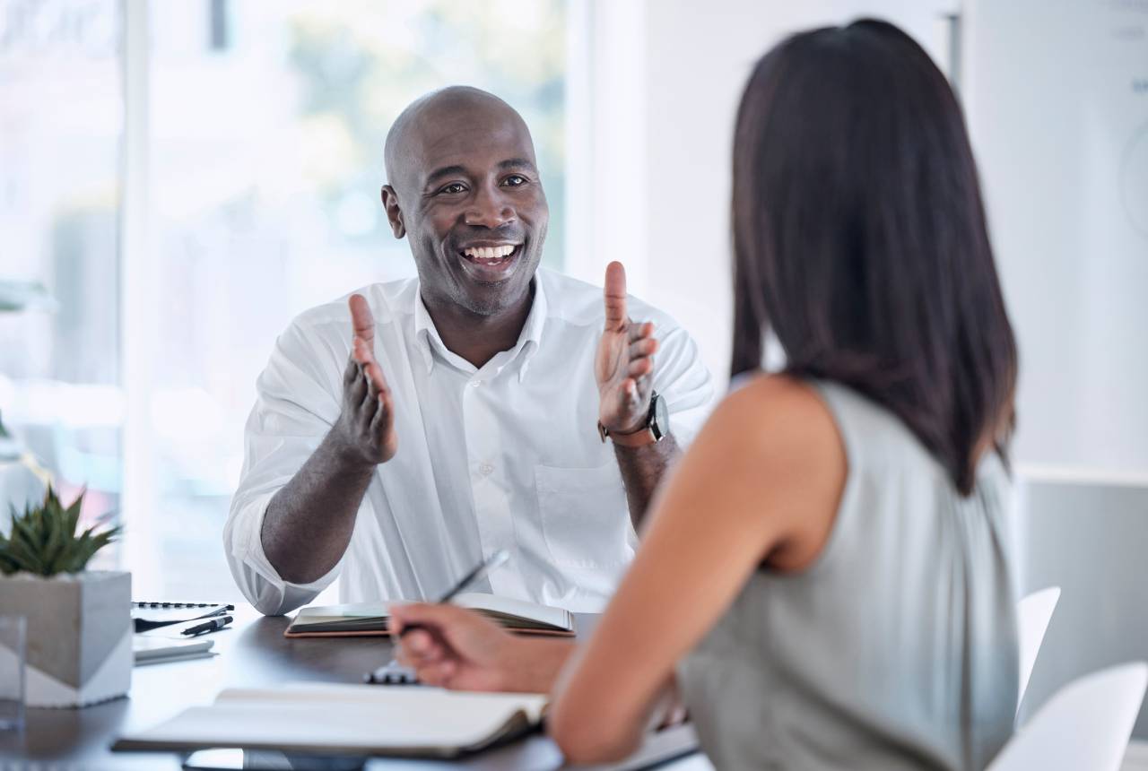 A man and woman are sitting at a table.