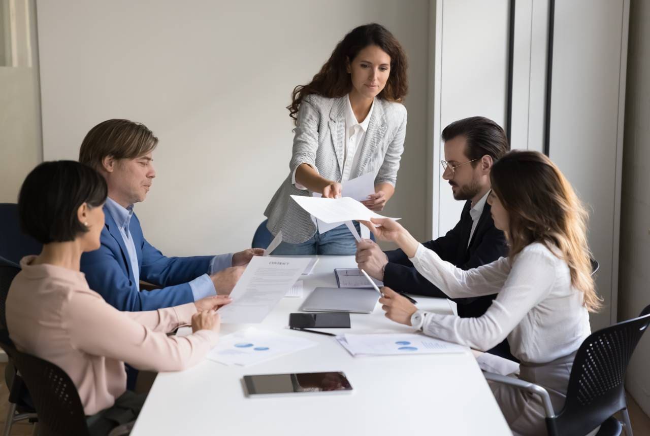 A group of people sitting around a table.